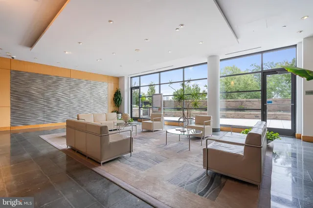 a lobby with furniture and large windows