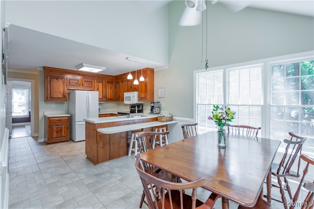 15008 Gates Mill Road Midlothian, VA 23112 - Photo 15 of 37 a kitchen with stainless steel appliances granite countertop a table chairs and a refrigerator