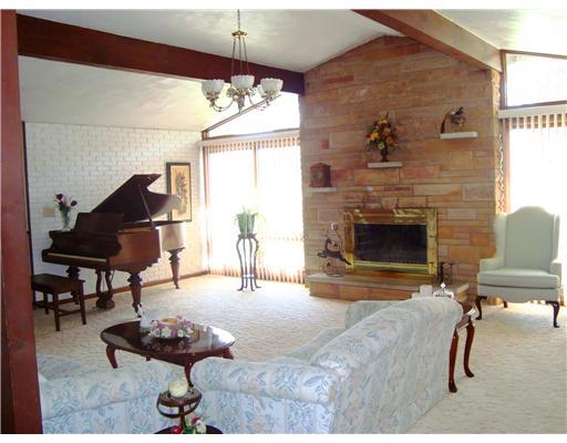 640 Deerfield Road Washington, PA 15301 - Photo 2 of 18 Living Room. Floor to roofline windows on both sides of the sandstone fireplace give abundant natural light and bring Nature inside. The grand piano indicates the scale of this room.