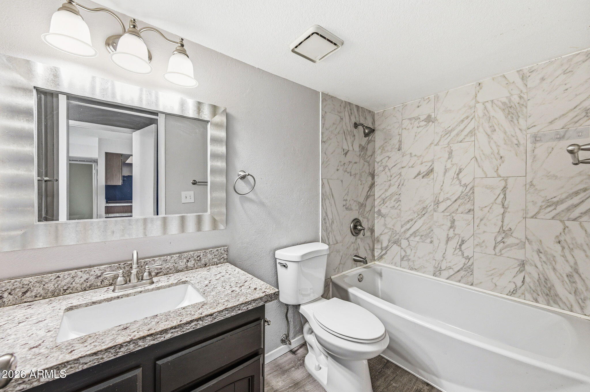 16635 North Cave Creek Road, Unit 215 Phoenix, AZ 85032 - Photo 14 of 27 a bathroom with a granite countertop toilet a sink and a bathtub