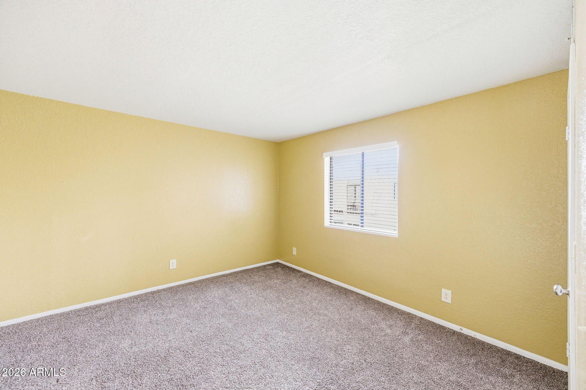 16635 North Cave Creek Road, Unit 215 Phoenix, AZ 85032 - Photo 16 of 27 an empty room with a window