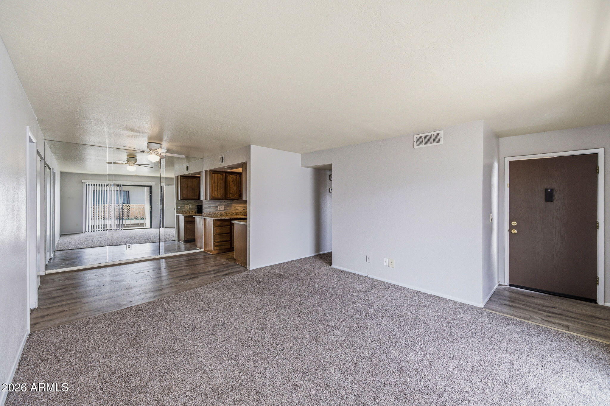 16635 North Cave Creek Road, Unit 215 Phoenix, AZ 85032 - Photo 4 of 27 a view of a big room with wooden cabinet and a kitchen