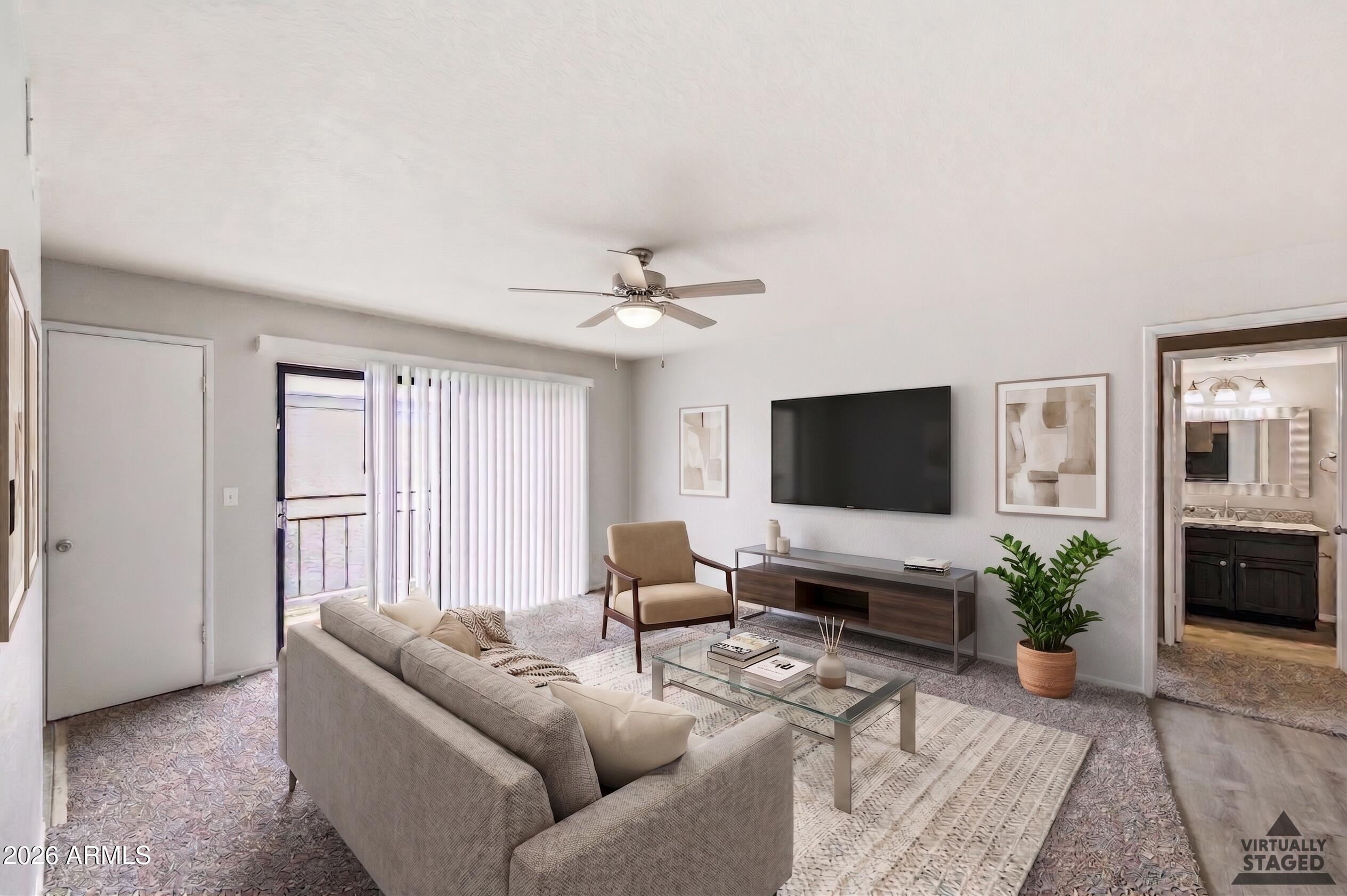 16635 North Cave Creek Road, Unit 215 Phoenix, AZ 85032 - Photo 6 of 27 a living room with furniture and a flat screen tv