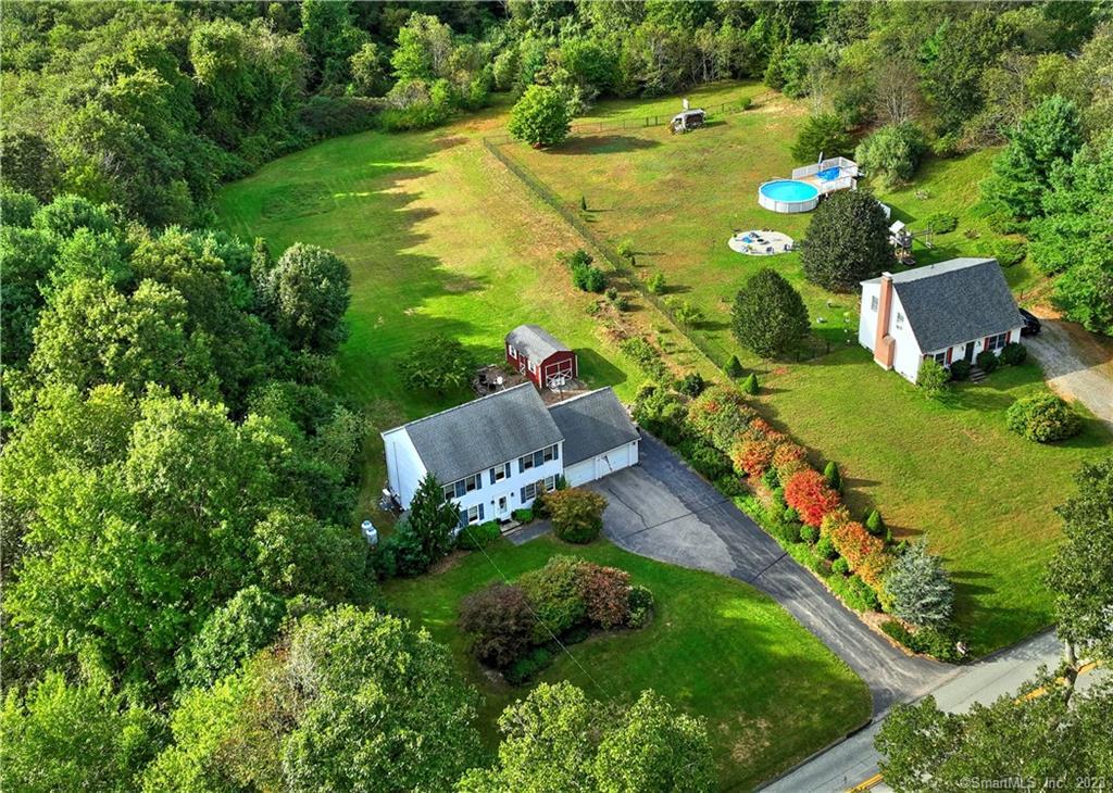 an aerial view of residential houses with outdoor space and street view