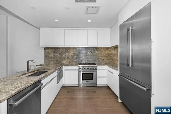 a kitchen with a sink stove and refrigerator
