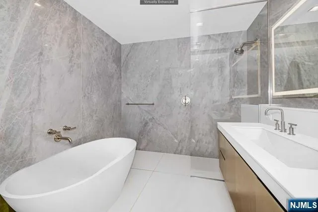 a bathroom with a sink a bathtub and shower