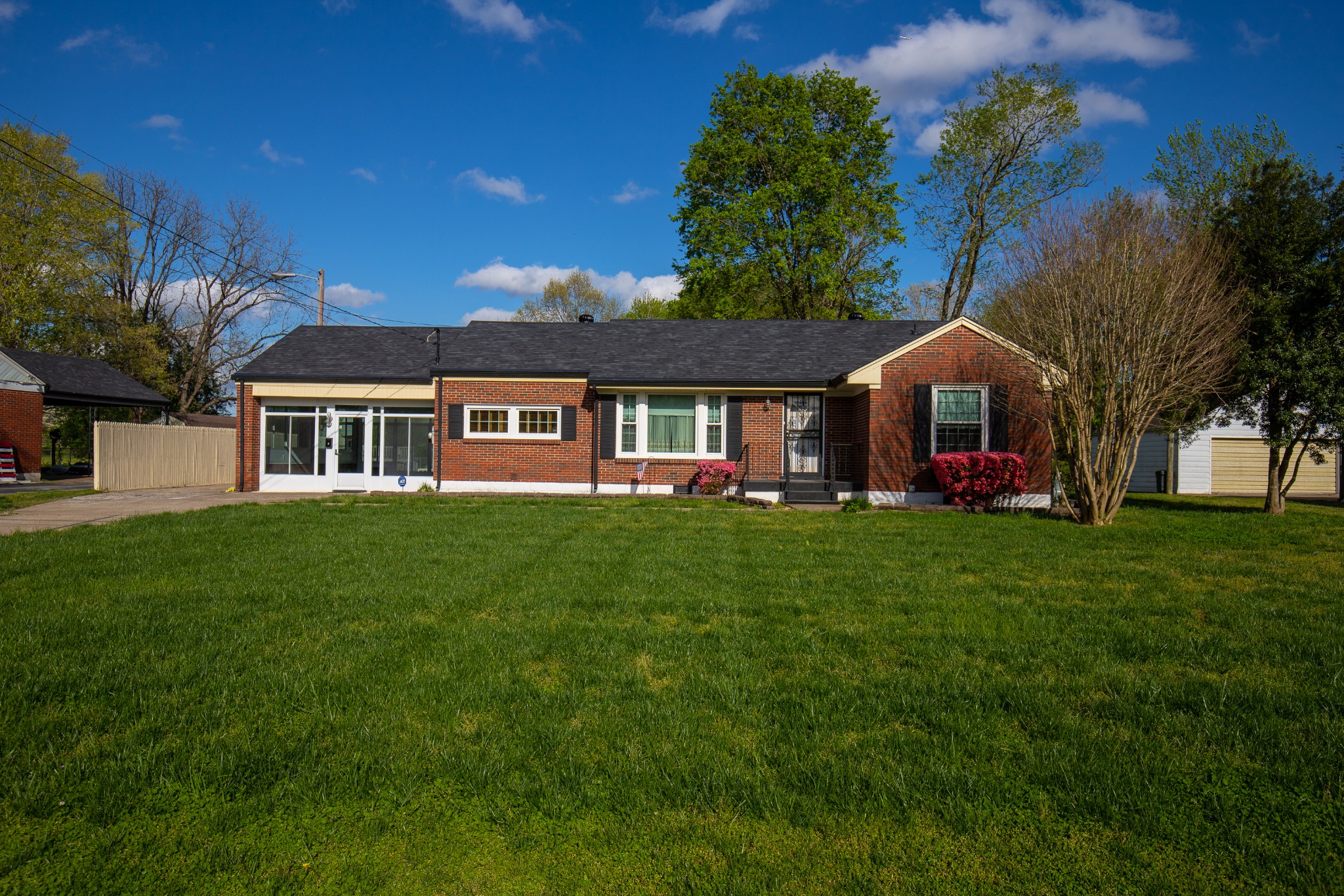 a front view of house with yard and green space