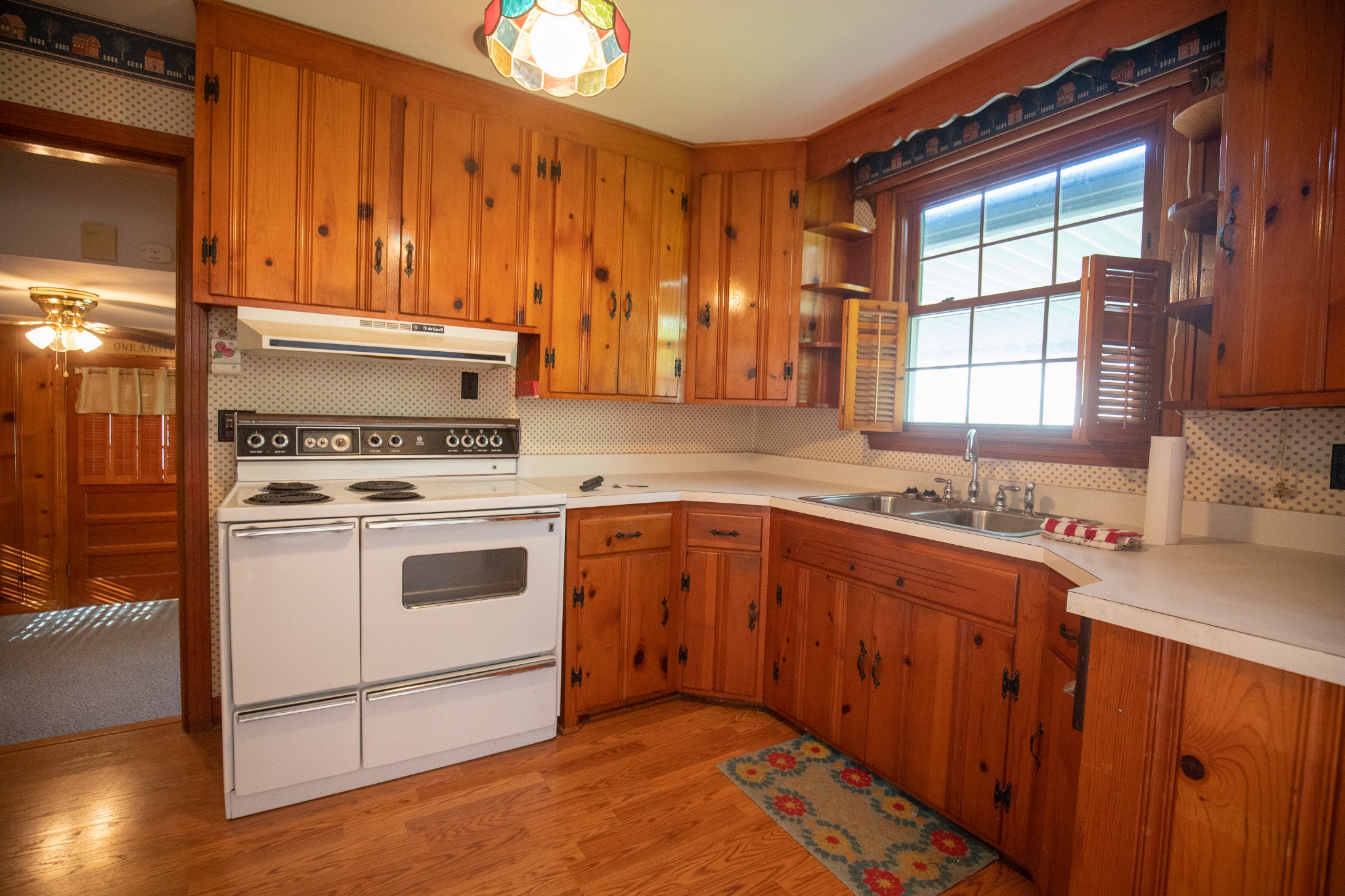 407 School Pass Madison, TN 37115 - Photo 5 of 15 a kitchen with wooden cabinets and white appliances