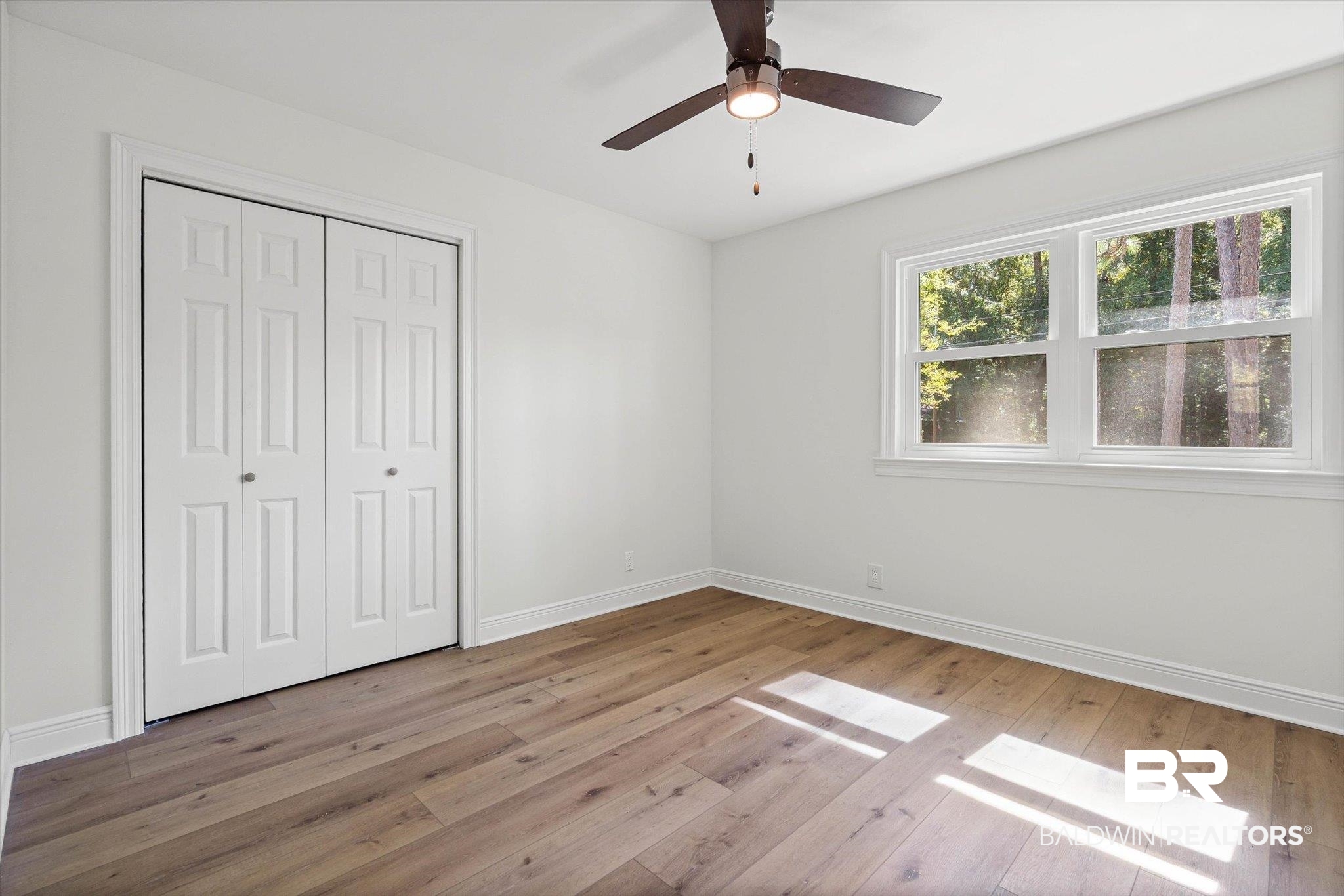 4156 Furman Drive Mobile, AL 36619 - Photo 17 of 24 Unfurnished bedroom featuring light wood-style flooring, a ceiling fan, and a closet