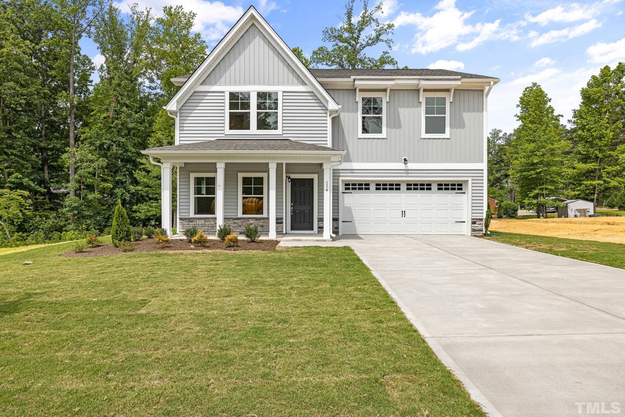 a view of a house with yard and deck