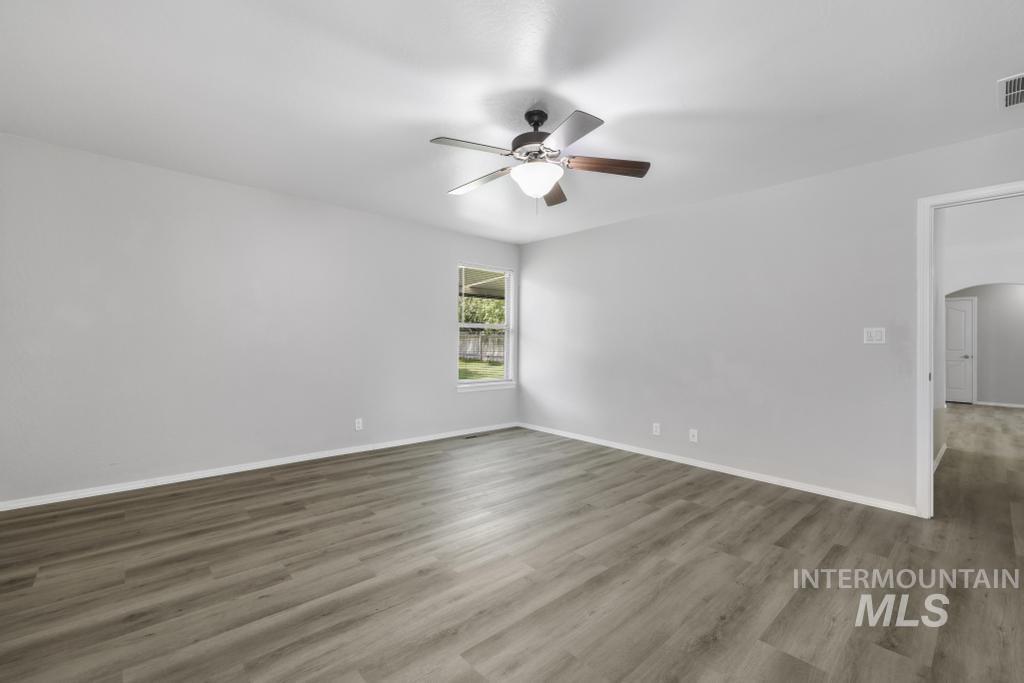 1183 Cortes Loop Twin Falls, ID 83301 - Photo 22 of 30 Spacious room featuring wood-finish flooring, light gray wall paint, and white baseboards