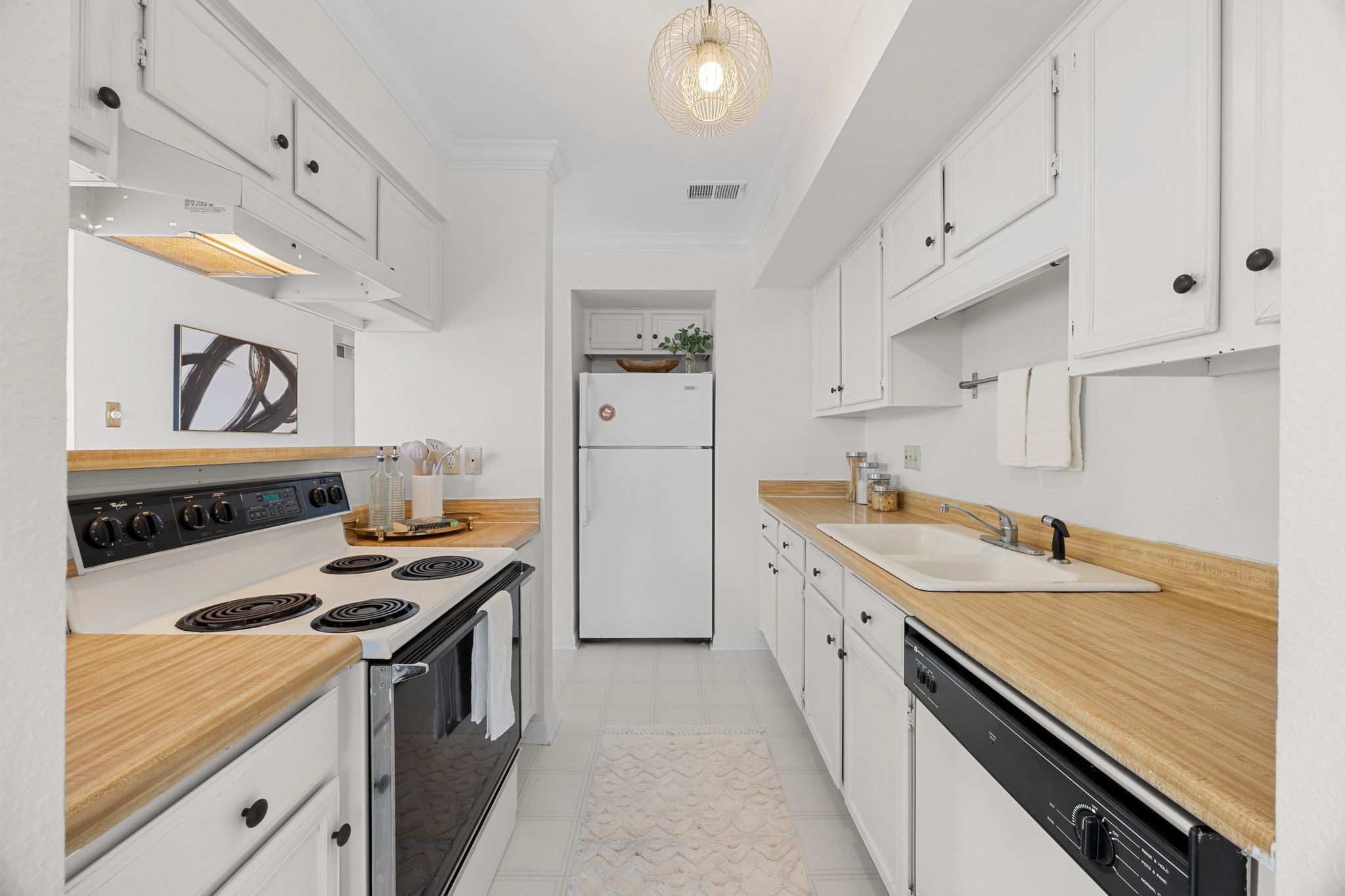 4159 Steck Avenue, Unit 258 Austin, TX 78759 - Photo 5 of 28 a kitchen with a sink stove and refrigerator