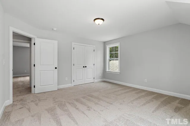 a view of empty room with ceiling fan