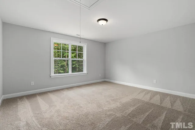 a view of a house with backyard and trees