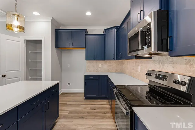 a room with a table chairs and a window