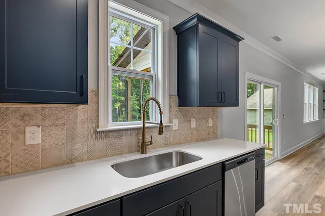 a view of empty room with fireplace and wooden floor