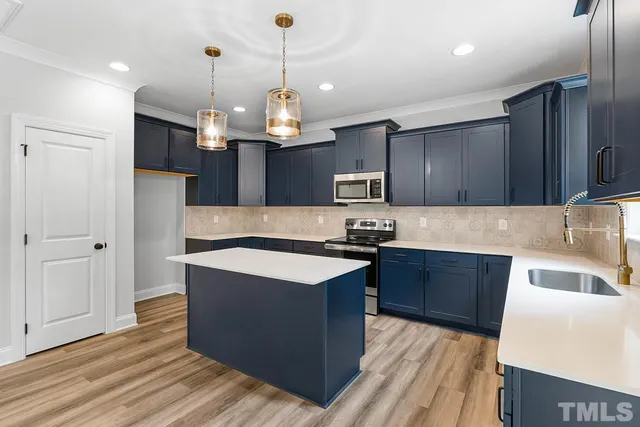 a view of a kitchen with a sink and a large window