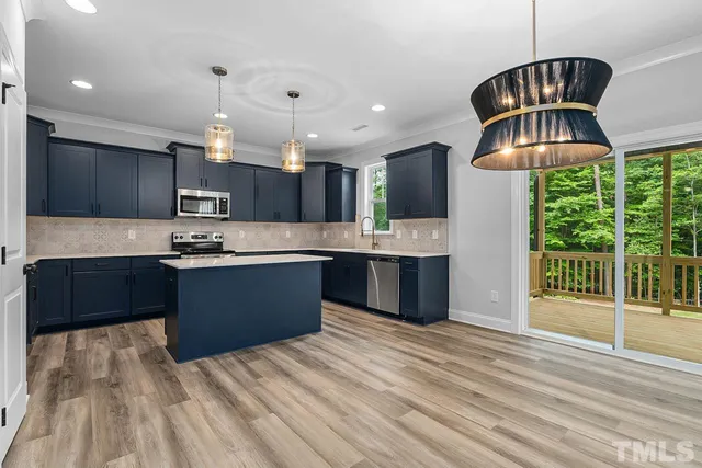 a view of a livingroom with an empty space and a fireplace
