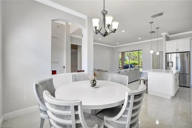 a dining room with furniture and chandelier