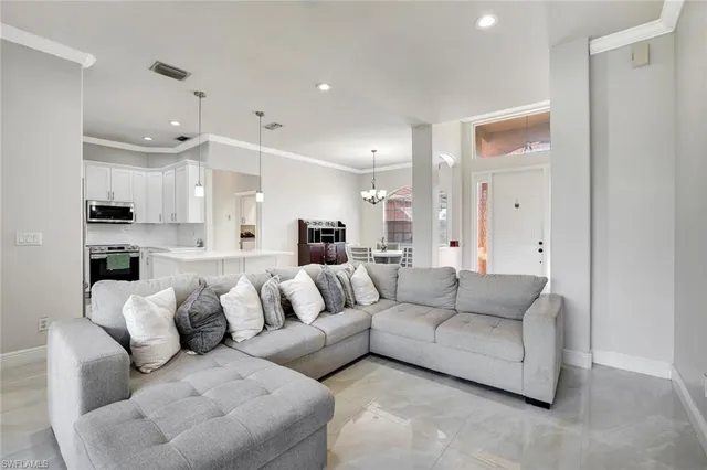 a living room with furniture white walls and white cabinets