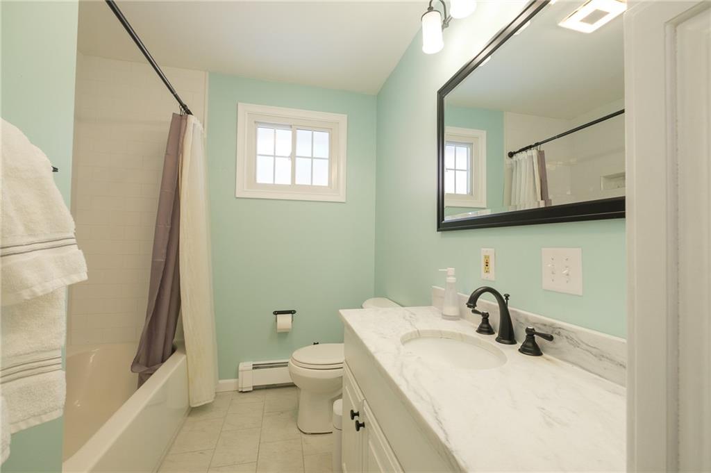 346 Wolf Run Road Industry, PA 15052 - Photo 11 of 25 a white toilet sitting next to a bathroom sink