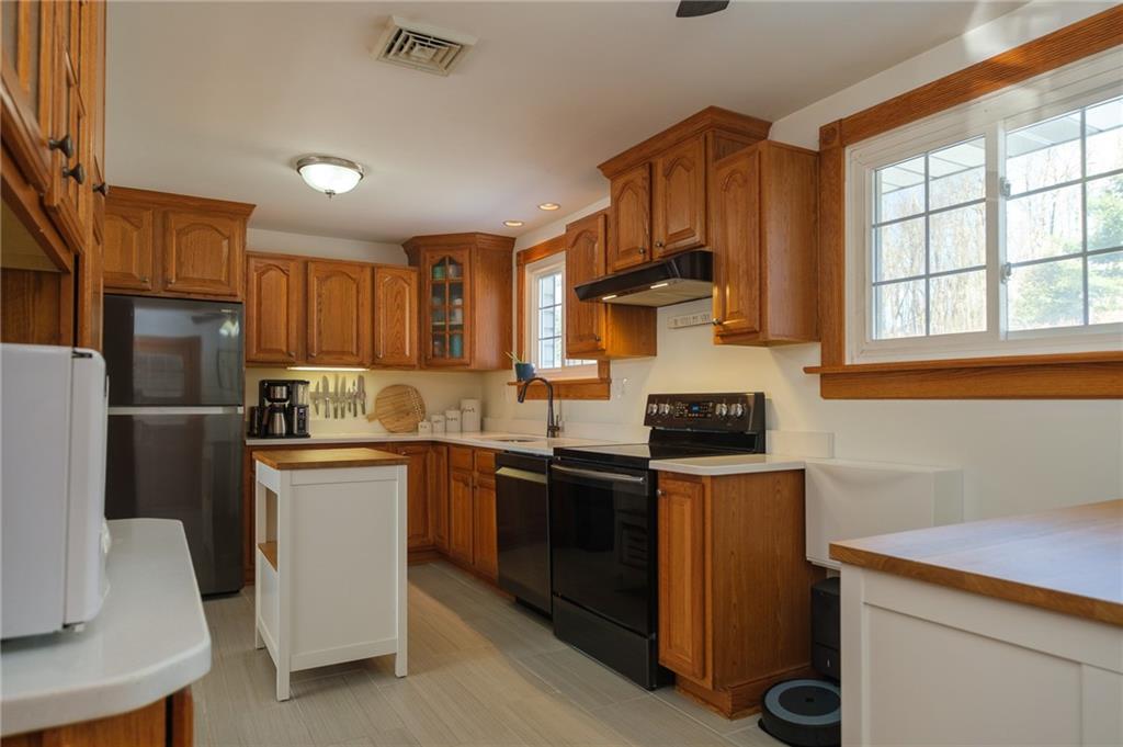 346 Wolf Run Road Industry, PA 15052 - Photo 8 of 25 a kitchen with stainless steel appliances granite countertop a stove a sink dishwasher a refrigerator and a microwave oven with wooden floor
