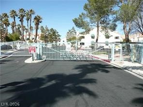 7570 West Flamingo Road, Unit 125 Las Vegas, NV 89147 - Photo 11 of 29 View of asphalt street with a gate, curbs, a gated entry, and sidewalks