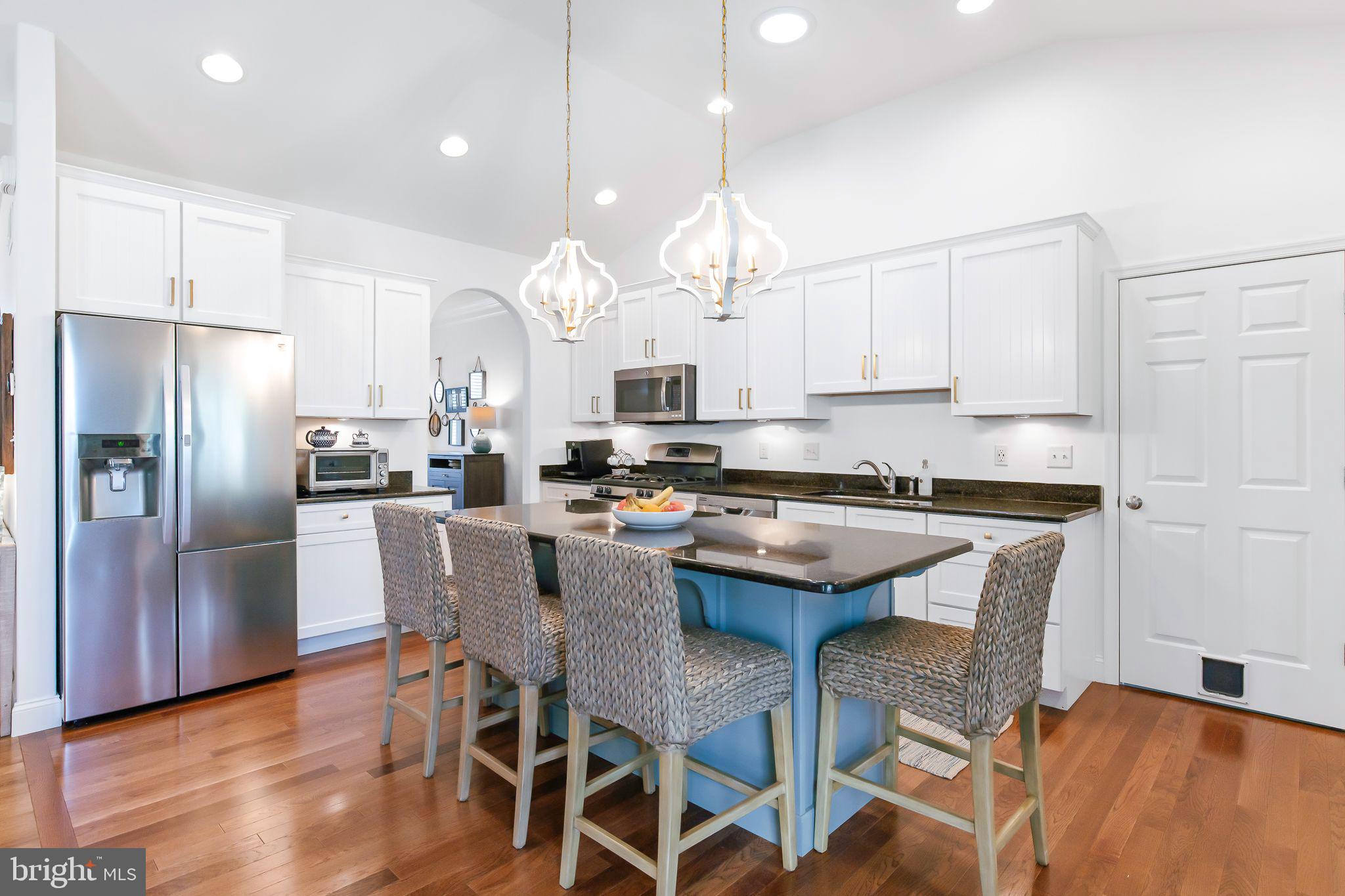 641 Dorset Street Lititz, PA 17543 - Photo 16 of 48 a kitchen with kitchen island granite countertop a center island a refrigerator and wooden floor