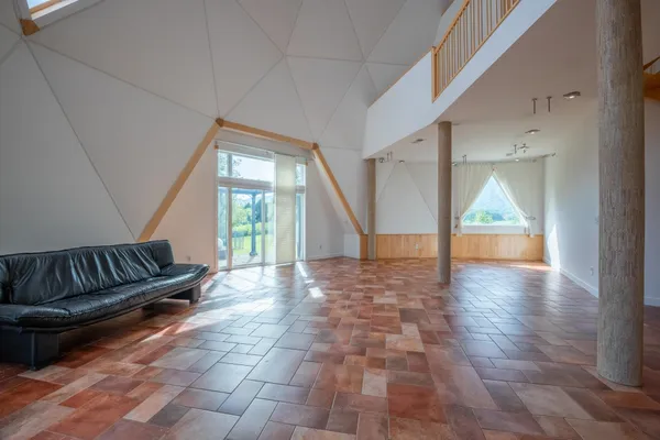 a walk in closet with wooden floor