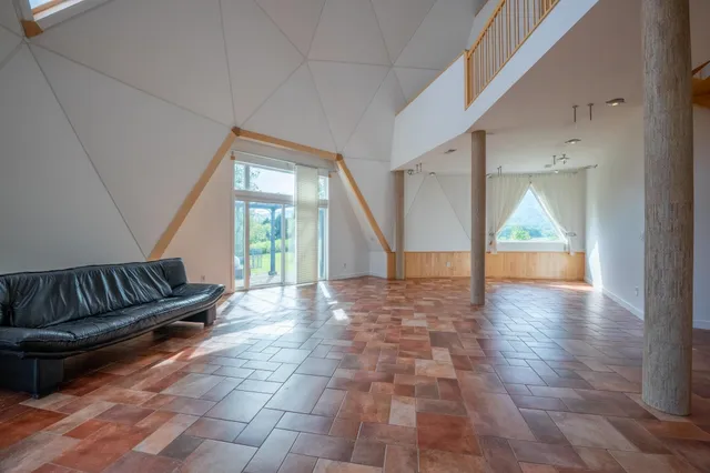 a walk in closet with wooden floor