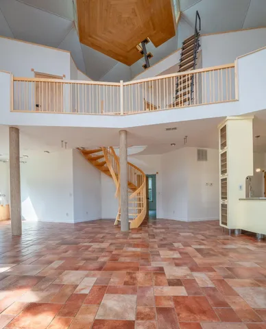 a kitchen with stainless steel appliances kitchen island granite countertop a refrigerator and a stove