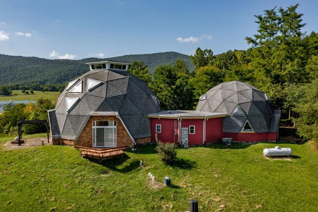 a view of a house with pool and a yard