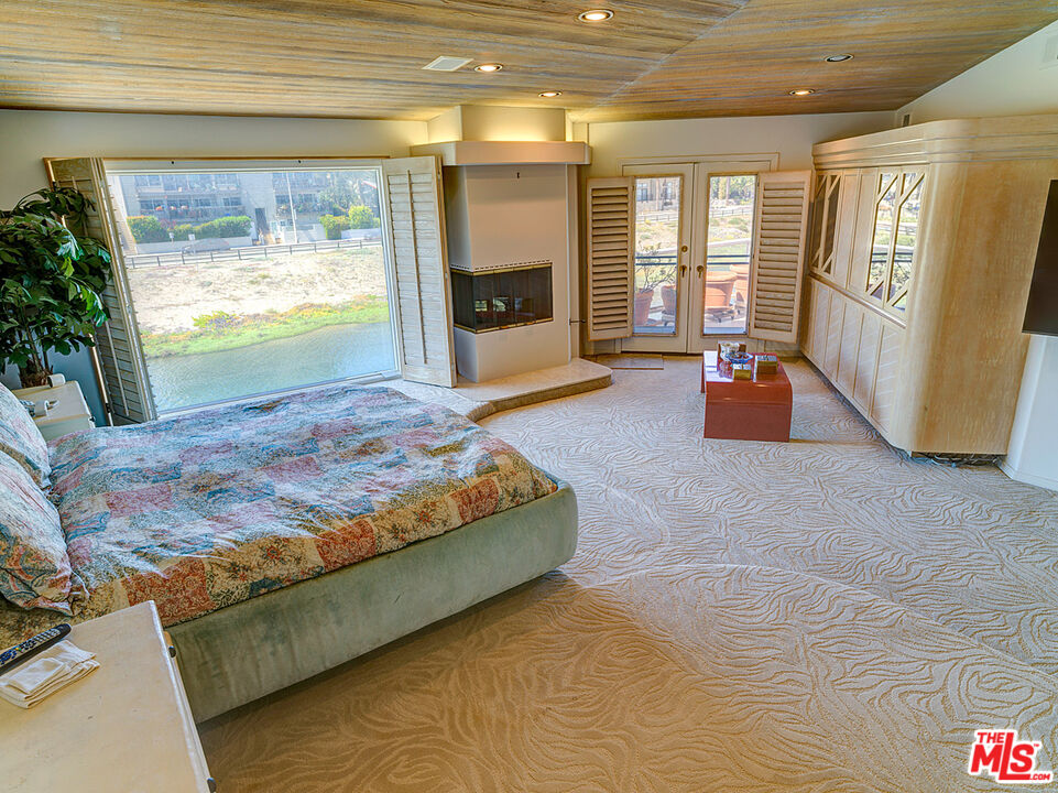4611 Roma Court Marina del Rey, CA 90292 - Photo 14 of 26 a bedroom with a bed and glass door