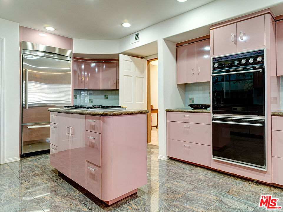 4611 Roma Court Marina del Rey, CA 90292 - Photo 9 of 26 a kitchen with stainless steel appliances granite countertop a stove a microwave and a refrigerator