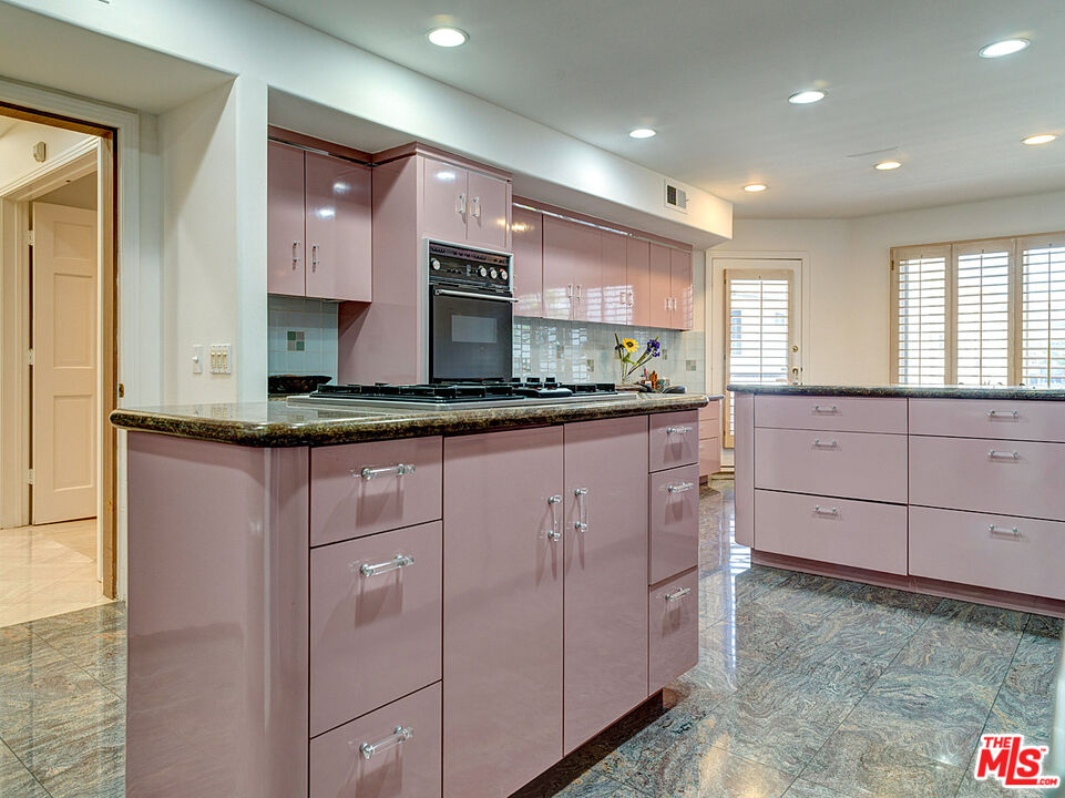 4611 Roma Court Marina del Rey, CA 90292 - Photo 10 of 26 a kitchen with kitchen island granite countertop a sink and cabinets