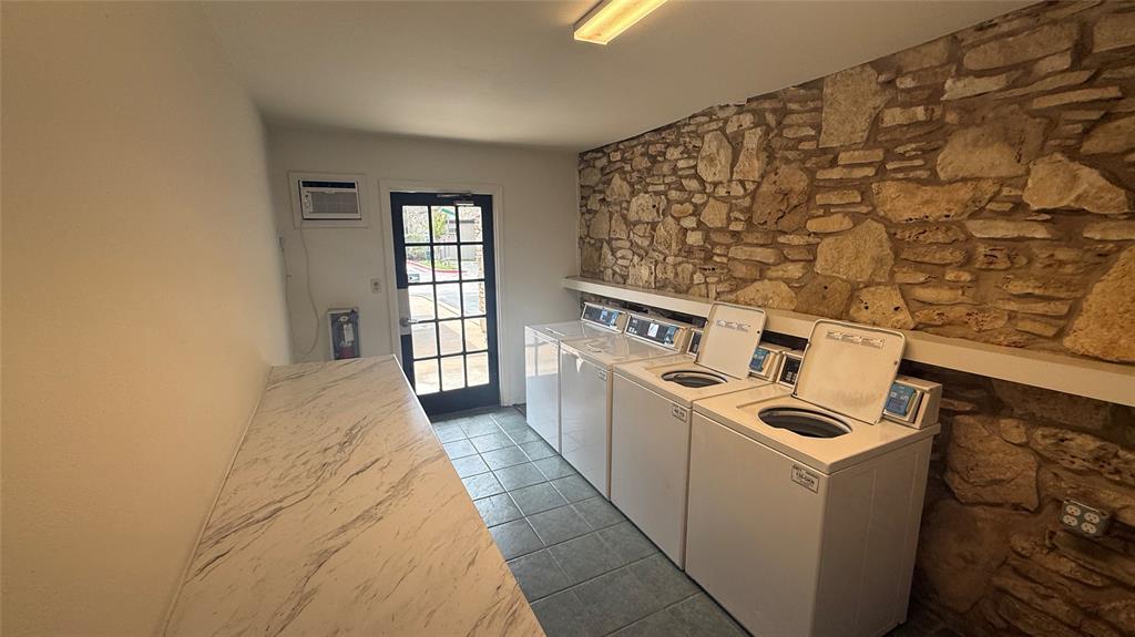 500 East Riverside Drive, Unit 132 Austin, TX 78704 - Photo 28 of 31 a room with a stove top oven and a wooden floor