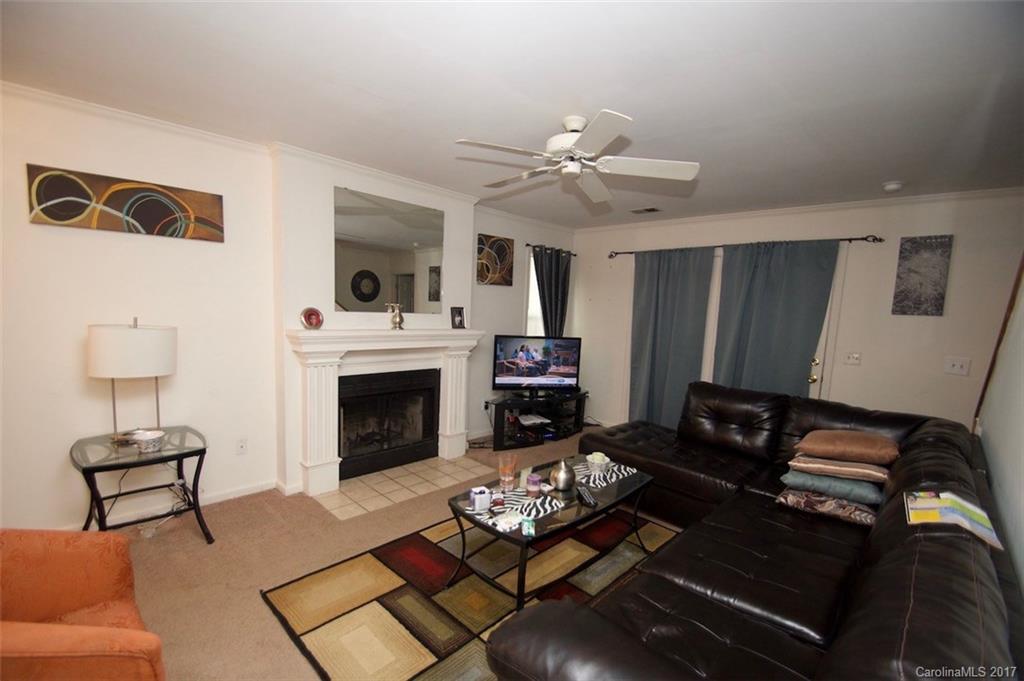 6728 Bevington Ridge Road Charlotte, NC 28277 - Photo 2 of 8 a living room with furniture and a fireplace