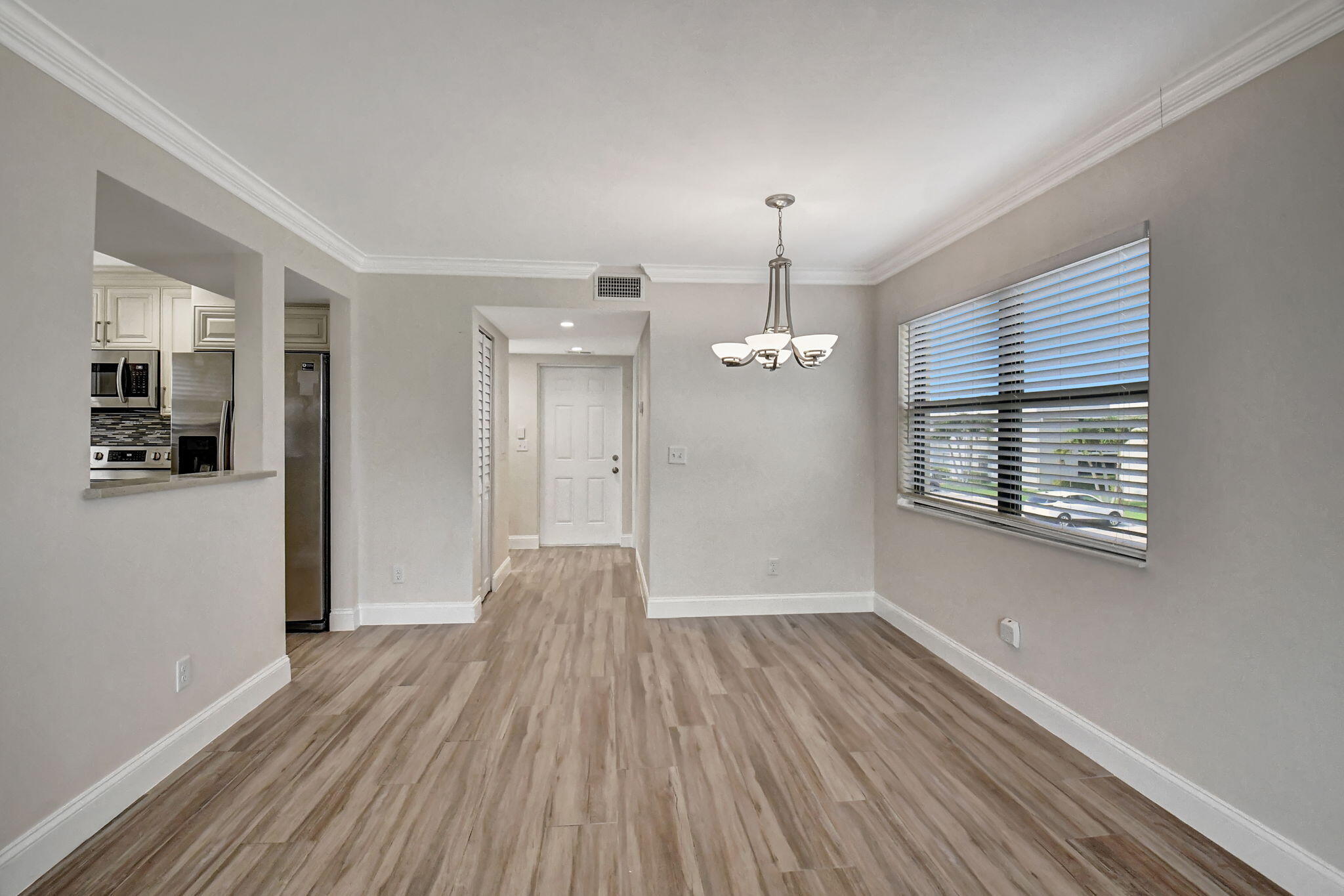 73 Capri B, Unit 73 Delray Beach, FL 33484 - Photo 33 of 93 a view of empty room with wooden floor and fan