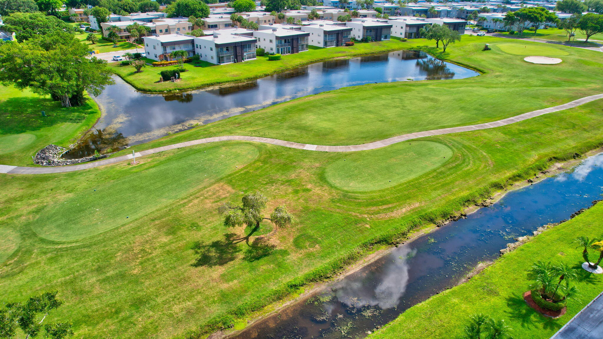 73 Capri B, Unit 73 Delray Beach, FL 33484 - Photo 57 of 93 a view of a swimming pool with a yard