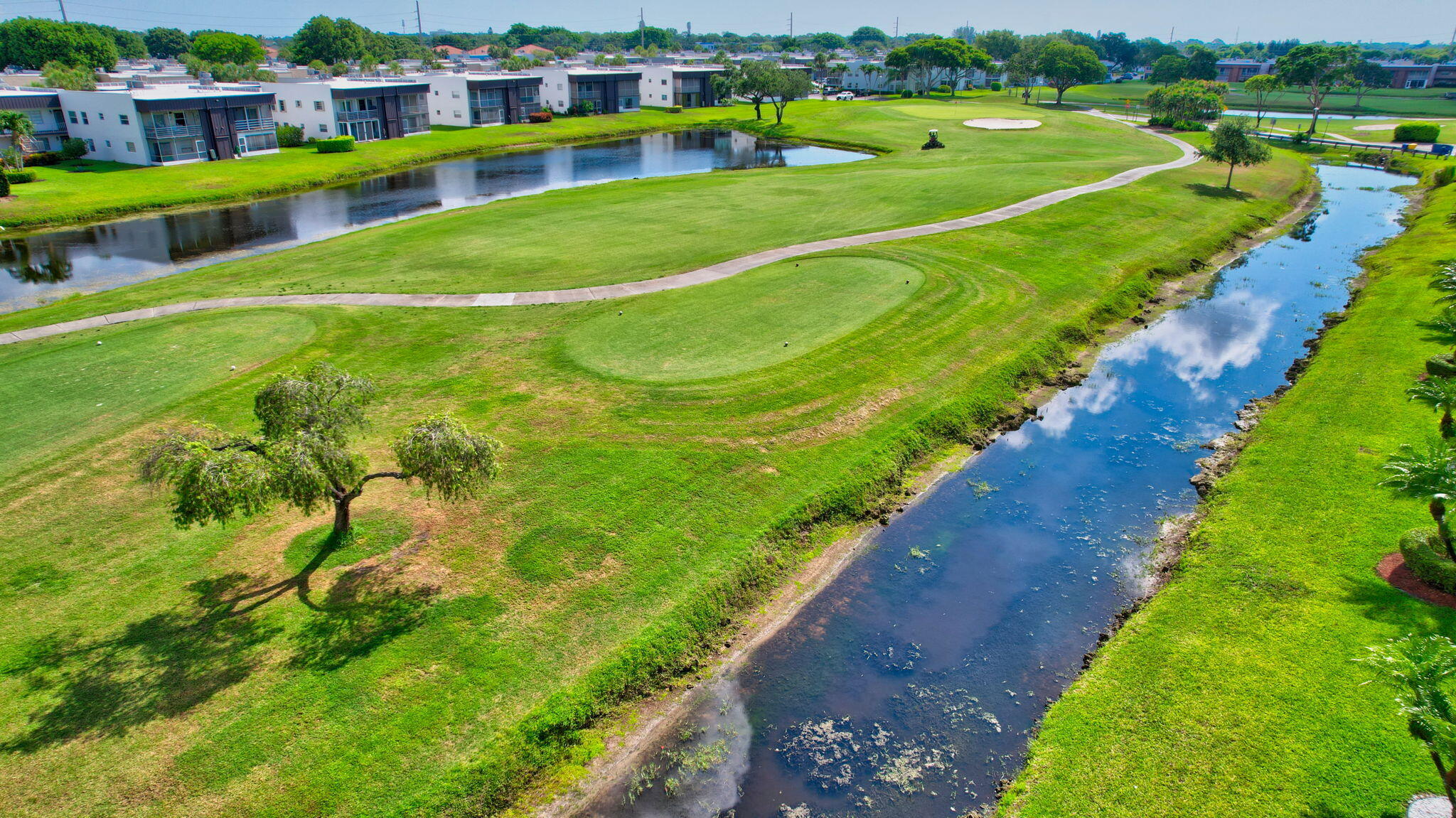73 Capri B, Unit 73 Delray Beach, FL 33484 - Photo 58 of 93 a view of a lake with a building in the background