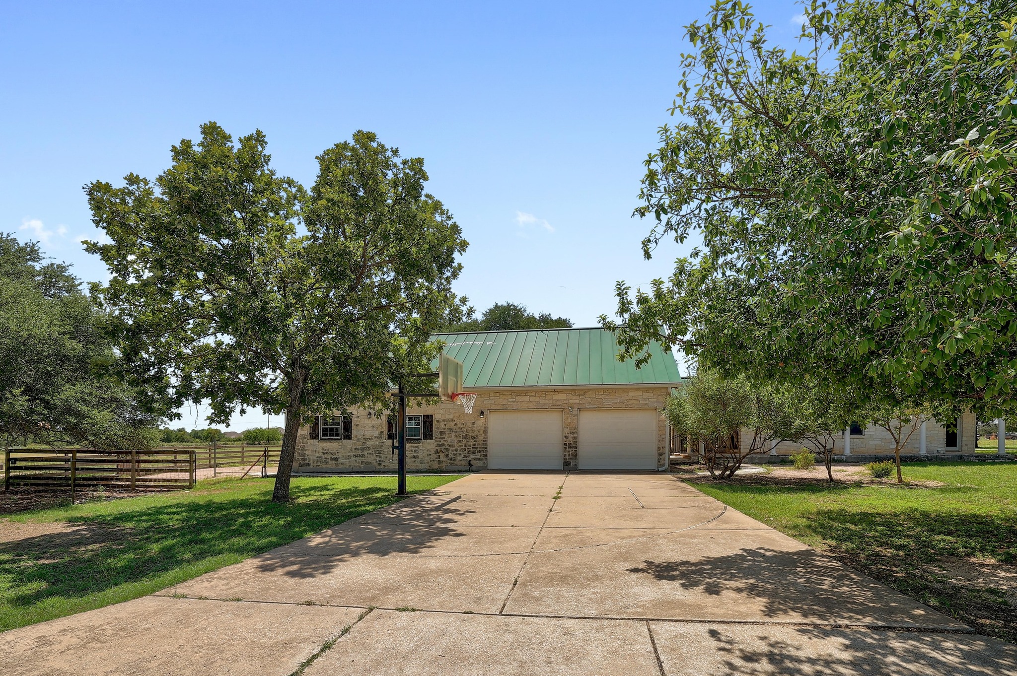 3900 Shell Road Georgetown, TX 78628 - Photo 30 of 40 View of front facade featuring a metal roof, brick siding, driveway, a standing seam roof, and a garage
