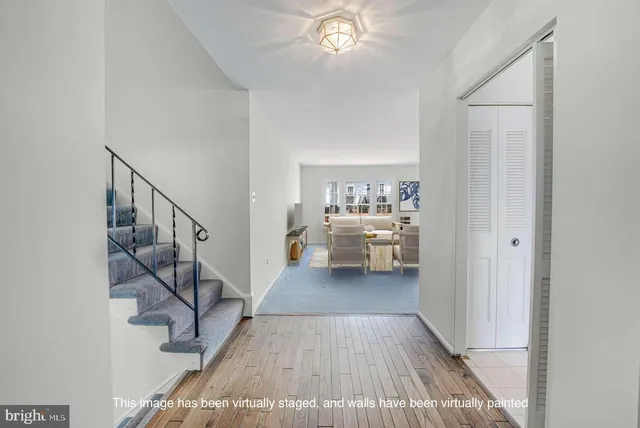 a view of a livingroom with wooden floor and stairs