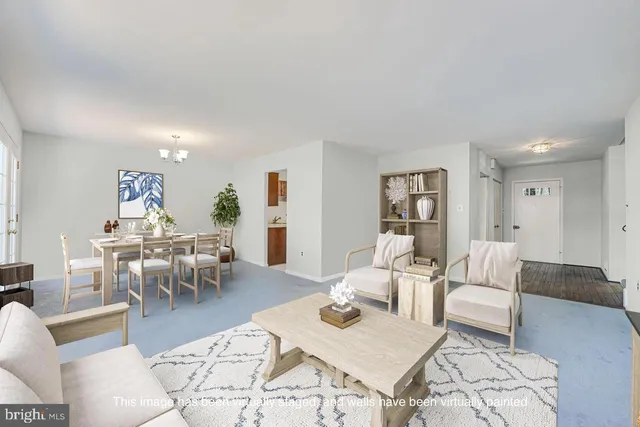 a living room with furniture a rug and a table