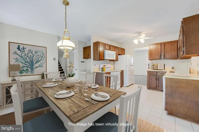 a living room with stainless steel appliances kitchen island a table and chairs