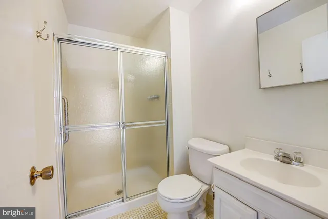 a bathroom with a shower a toilet and a sink