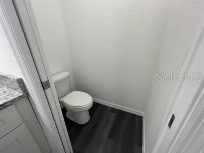 a white toilet sitting next to a shower