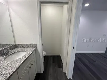 a bathroom with a granite countertop sink and a mirror