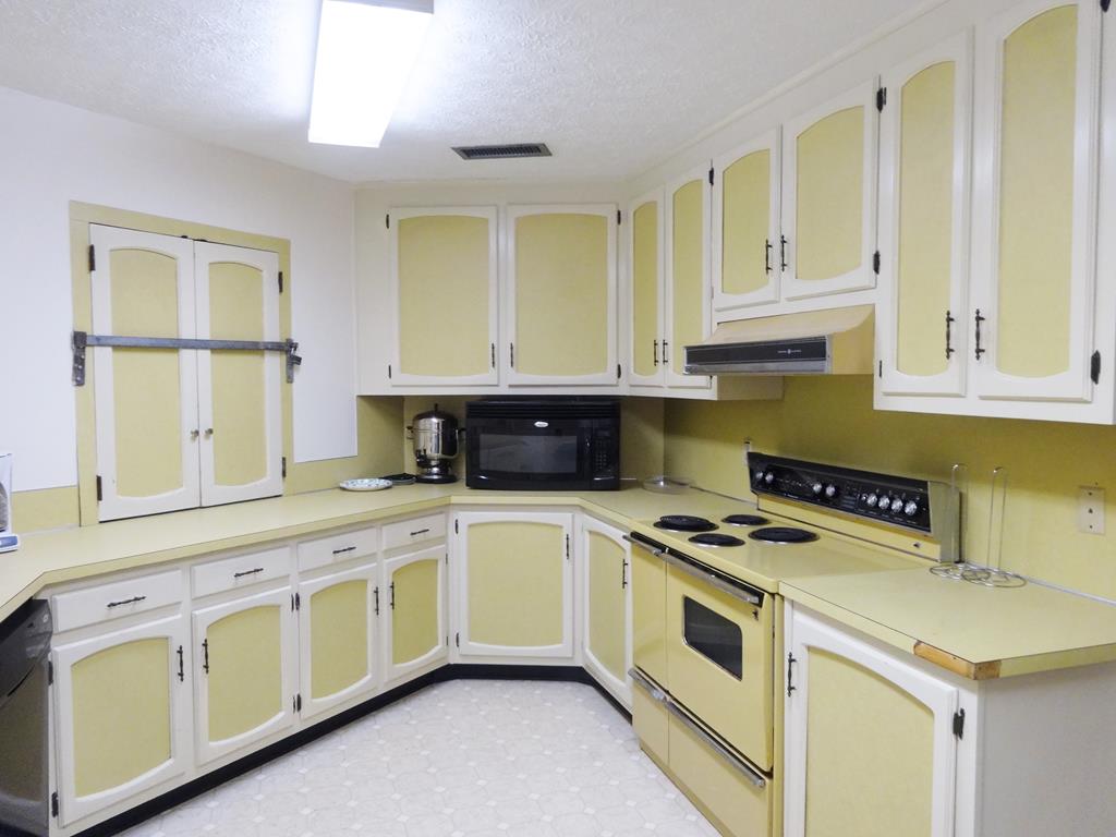 2525 Norris Road, Unit 113 Columbus, GA 31907 - Photo 34 of 40 a kitchen with granite countertop white cabinets and white appliances