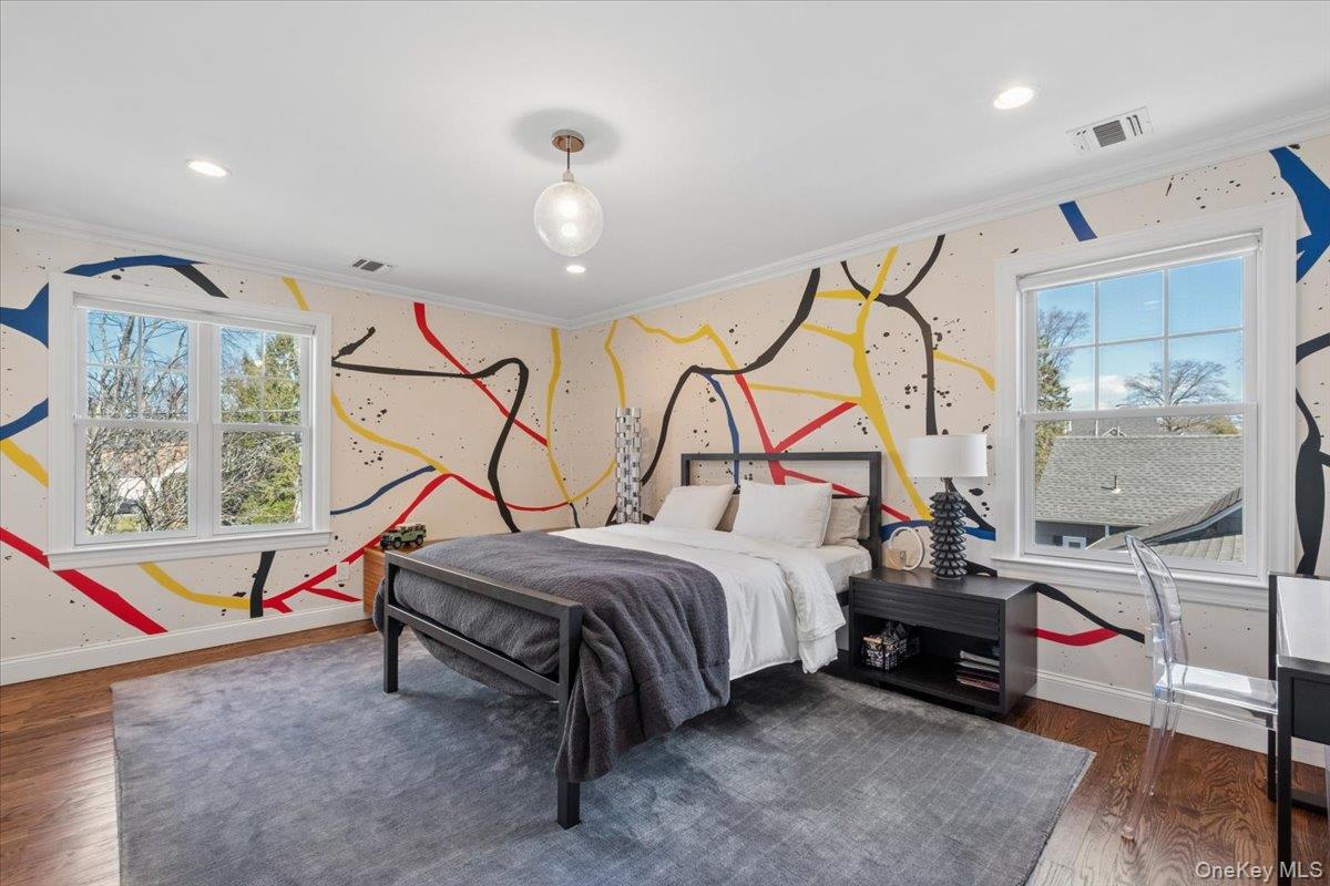 73 Atherstone Road Scarsdale, NY 10583 - Photo 20 of 34 a bedroom with a bed a mirror and lamp