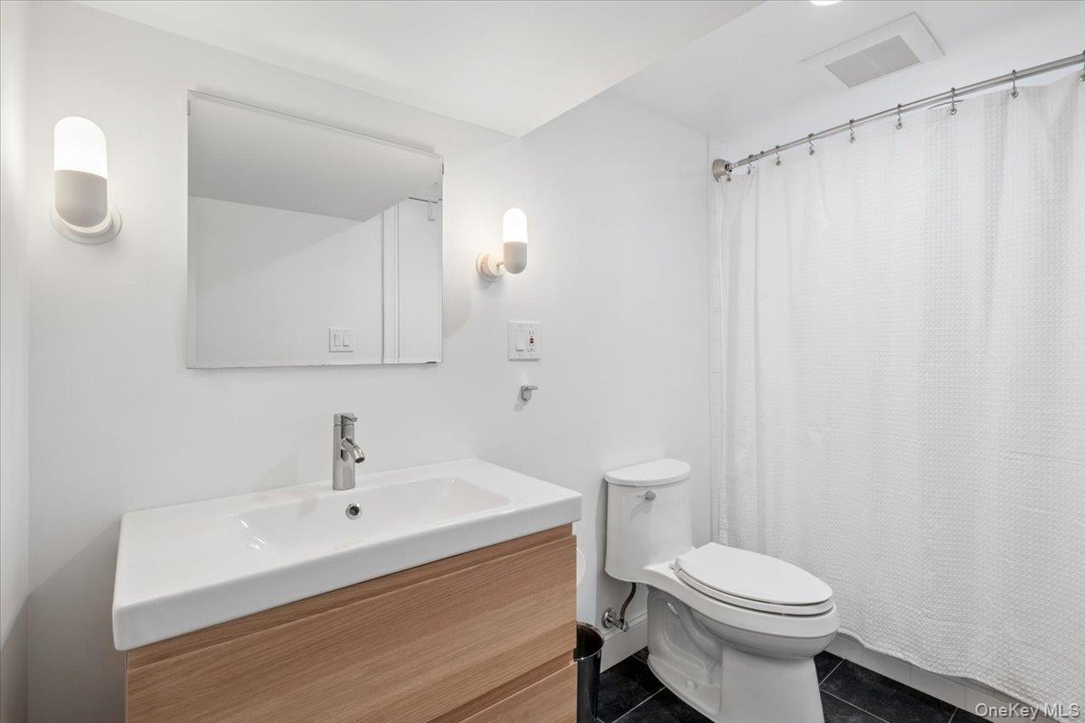 73 Atherstone Road Scarsdale, NY 10583 - Photo 24 of 34 a bathroom with a sink a toilet and shower